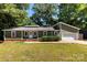 Charming single-story home with green siding, a well-manicured lawn, and an attached garage at 619 Archibald Rd, Concord, NC 28025