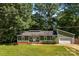 Green ranch home with a well-kept lawn, attached garage, and inviting curb appeal, perfect for comfortable living at 619 Archibald Rd, Concord, NC 28025