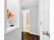 Hallway view of bathroom with tan tile shower and neutral decor at 619 Archibald Rd, Concord, NC 28025