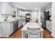 Bright kitchen with gray cabinets, granite counters, stainless appliances, and hardwood floors at 619 Archibald Rd, Concord, NC 28025
