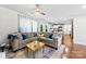 Cozy living area with a sectional sofa, hardwood floors, and easy access to an open kitchen space at 619 Archibald Rd, Concord, NC 28025