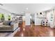 Bright living room with hardwood floors, a sectional sofa, and seamless transition to the kitchen at 619 Archibald Rd, Concord, NC 28025