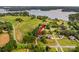 Aerial view showcases home near vast farmland with gorgeous water views at 7923 Mountain Shore Dr, Sherrills Ford, NC 28673
