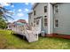 Spacious backyard with wooden deck, sun umbrella, and two-story home at 7923 Mountain Shore Dr, Sherrills Ford, NC 28673