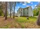 View of backyard with deck, two-story house, and lush green surroundings at 7923 Mountain Shore Dr, Sherrills Ford, NC 28673