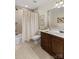 Bathroom with neutral walls, patterned shower curtain and wooden cabinets at 7923 Mountain Shore Dr, Sherrills Ford, NC 28673