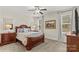 Cozy bedroom with a wooden bed frame, carpet flooring, and natural lighting at 7923 Mountain Shore Dr, Sherrills Ford, NC 28673