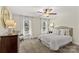 Bedroom featuring neutral walls, carpet, two windows, and a ceiling fan at 7923 Mountain Shore Dr, Sherrills Ford, NC 28673