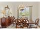 Formal dining room with a dark wood table set, chandelier, and decorative mirror at 7923 Mountain Shore Dr, Sherrills Ford, NC 28673