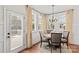 Cozy dining area featuring hardwood floors, elegant curtains, and access to the outdoor patio at 7923 Mountain Shore Dr, Sherrills Ford, NC 28673