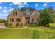 Charming brick home featuring a well-maintained lawn, manicured shrubbery, and an inviting front entrance at 7923 Mountain Shore Dr, Sherrills Ford, NC 28673