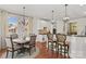 Charming kitchen area with a breakfast bar, and an adjacent dining space with a chandelier at 7923 Mountain Shore Dr, Sherrills Ford, NC 28673
