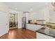 Spacious kitchen featuring white cabinets, stainless steel refrigerator, and hardwood floors at 7923 Mountain Shore Dr, Sherrills Ford, NC 28673
