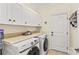 Bright laundry room with white cabinetry, countertop, and modern Samsung washer and dryer at 7923 Mountain Shore Dr, Sherrills Ford, NC 28673