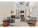 Elegant living room with high ceilings, a cozy fireplace, and large windows providing natural light at 7923 Mountain Shore Dr, Sherrills Ford, NC 28673