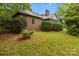 Backyard with brick house and wooden deck amid lush landscaping at 8368 Fairfield Forest Rd, Denver, NC 28037