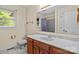 Bathroom with cherry vanity, a white countertop, tiled floors, and a window for natural light at 8368 Fairfield Forest Rd, Denver, NC 28037
