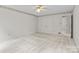 Spacious bedroom has white carpet, neutral walls, and double closet doors at 8368 Fairfield Forest Rd, Denver, NC 28037
