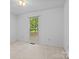 Bright bedroom with a single window, white walls, and carpeted floors create a neutral and bright space at 8368 Fairfield Forest Rd, Denver, NC 28037