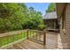 Wooden deck overlooking the manicured yard, with access to screened in porch at 8368 Fairfield Forest Rd, Denver, NC 28037