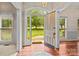 Inviting foyer with hardwood floors and an open doorway leading to a lush front yard at 8368 Fairfield Forest Rd, Denver, NC 28037