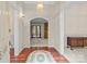Warm foyer showcasing hardwood floors, and arched doorways leading to other living spaces at 8368 Fairfield Forest Rd, Denver, NC 28037