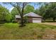 Brick home with a two car garage, private back yard, mature trees and wooden deck at 8368 Fairfield Forest Rd, Denver, NC 28037
