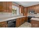 Functional kitchen featuring wood cabinets, black appliances, and practical layout at 8368 Fairfield Forest Rd, Denver, NC 28037