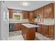 Traditional kitchen features wood cabinets, an island, and black appliances at 8368 Fairfield Forest Rd, Denver, NC 28037