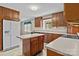 Traditional kitchen featuring wooden cabinets, island, white appliances, and light countertops at 8368 Fairfield Forest Rd, Denver, NC 28037