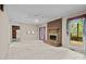 Open living room with a brick fireplace, plush carpeting, and access to the kitchen at 8368 Fairfield Forest Rd, Denver, NC 28037