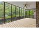 Screened patio with wood decking and a ceiling fan, perfect for relaxation at 8368 Fairfield Forest Rd, Denver, NC 28037