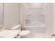 Clean bathroom featuring a shower-tub combo with modern fixtures and all-white cabinets at 9612 Pointer Rd # 59, Huntersville, NC 28078