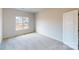 Bedroom with a window, carpet flooring, and a white door at 9612 Pointer Rd # 59, Huntersville, NC 28078
