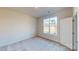 Bedroom with a window, carpet flooring, and white doors at 9612 Pointer Rd # 59, Huntersville, NC 28078