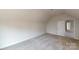 A comfortable bedroom featuring carpet and a door that leads to a well-lit hallway at 9612 Pointer Rd # 59, Huntersville, NC 28078