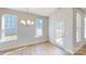 Bright dining area with wood floors, a modern light fixture, and a glass door to the outside at 9612 Pointer Rd # 59, Huntersville, NC 28078