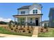 Charming two-story home features a landscaped yard, stone accents, and a welcoming front porch at 9612 Pointer Rd # 59, Huntersville, NC 28078