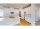 Bright, open kitchen with white cabinets, stainless appliances, island, and hard wood floors at 9612 Pointer Rd # 59, Huntersville, NC 28078