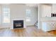 Bright living room with fireplace, wood floors, and lots of natural light from the many windows at 9612 Pointer Rd # 59, Huntersville, NC 28078