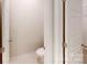A conveniently located powder room with a modern toilet and sleek white tile flooring at 9612 Pointer Rd # 59, Huntersville, NC 28078
