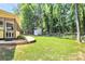 Well-maintained backyard with a level lawn, shed, and mature trees, providing a serene outdoor space at 9930 Karras Commons Way, Matthews, NC 28105