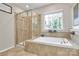 Elegant bathroom featuring a separate shower and tub, with tile surround at 9930 Karras Commons Way, Matthews, NC 28105