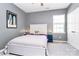 Bright bedroom featuring a white bed frame, soft carpeting, and neutral wall color, creating a relaxing atmosphere at 9930 Karras Commons Way, Matthews, NC 28105