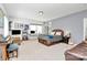 Large bedroom with a desk, bed, chair, and brown leather sofa at 9930 Karras Commons Way, Matthews, NC 28105