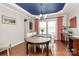 Formal dining room with a blue trey ceiling, wood floors, and a large table at 9930 Karras Commons Way, Matthews, NC 28105