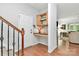Welcoming entryway with a built-in desk area, coat hooks, and adjacent staircase at 9930 Karras Commons Way, Matthews, NC 28105