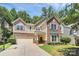 Beautiful two-story home with stone and siding exterior, attached garage, and basketball hoop at 9930 Karras Commons Way, Matthews, NC 28105