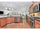 Open kitchen with stainless steel appliances, granite countertops, and hardwood floors at 9930 Karras Commons Way, Matthews, NC 28105