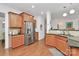 Open kitchen design featuring stainless steel appliances and wood cabinets at 9930 Karras Commons Way, Matthews, NC 28105